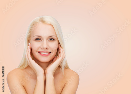 beautiful woman touching her face skin
