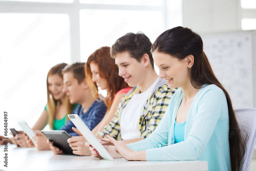 smiling students with tablet pc at school smiling students with tablet pc at school