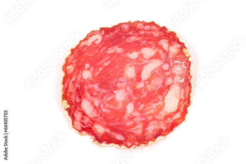 Slice of salami sausage on a white background