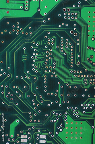 Green computer board with chips and components.