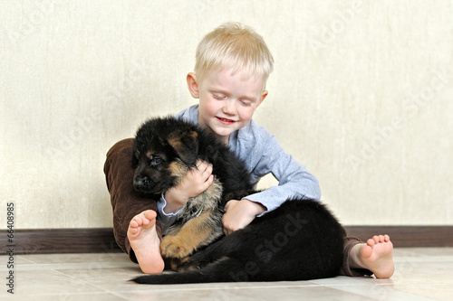 portrait of a little boy with a puppy