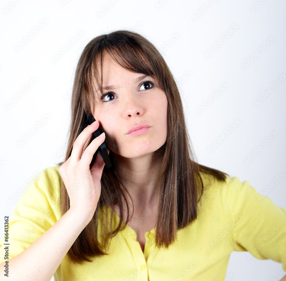 Beautiful woman talking on cellphone and being in shock of news