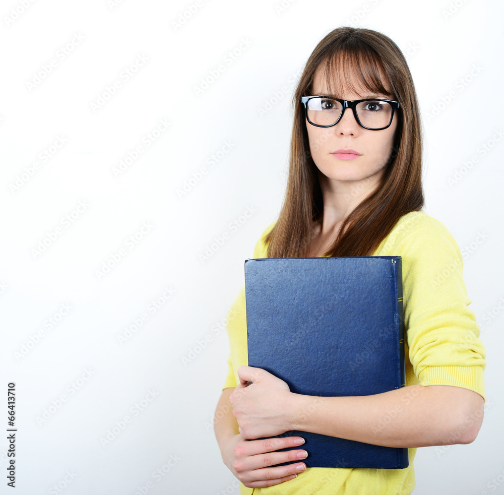 Happy young student women holding books in her hand while standi Happy young student women holding books in her hand while standi