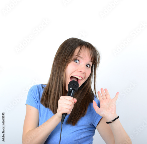 Portrait of a young female with microphone against white backgro