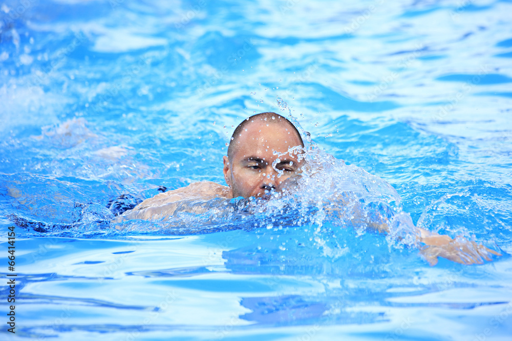 Man swims in the outdoor pool.