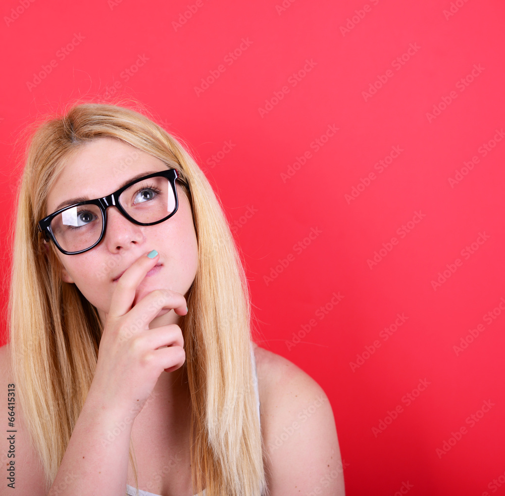 Portrait of beautiful girl looking up against red background Portrait of beautiful girl looking up against red background
