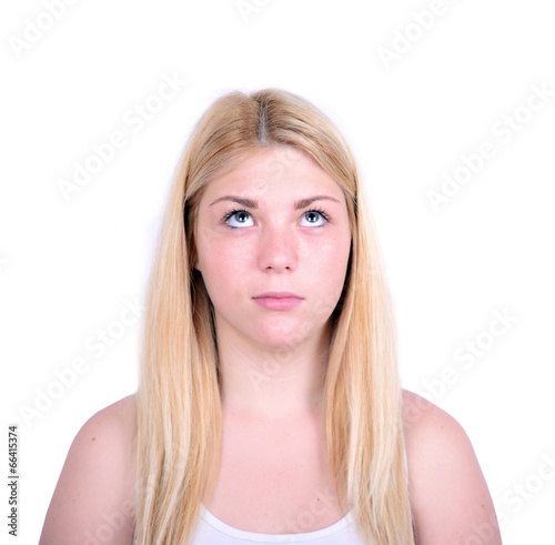 Portrait of beautiful girl looking up against white background
