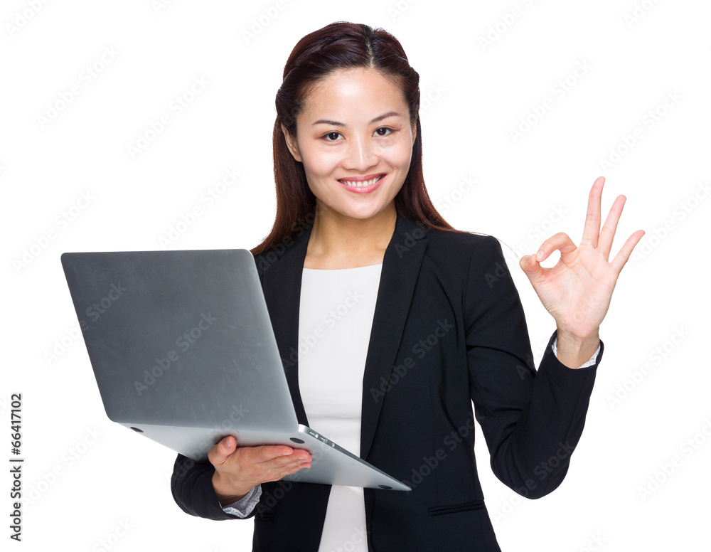 Businesswoman hold laptop computer with ok sign Businesswoman hold laptop computer with ok sign