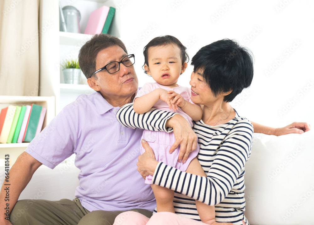 asian grand parents comforting their spoilt crying grand daugthe asian grand parents comforting their spoilt crying grand daugthe