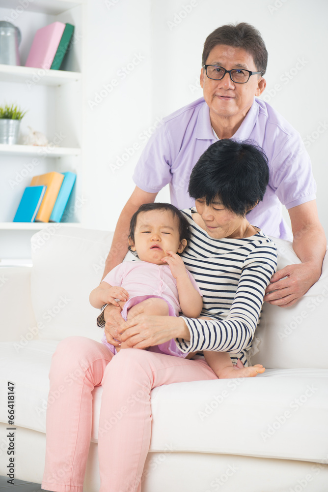 asian grand parents comforting their spoilt crying grand daugthe asian grand parents comforting their spoilt crying grand daugthe