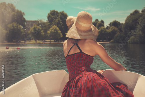 Woman in rowing boat looking at lake photo