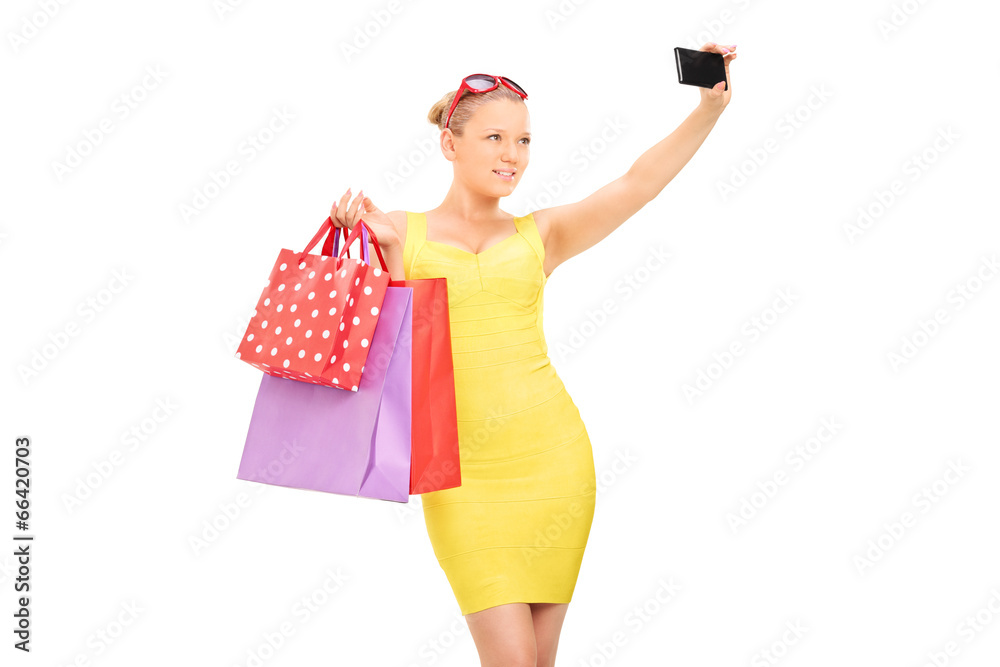 Classy girl with shopping bags taking a selfie Classy girl with shopping bags taking a selfie