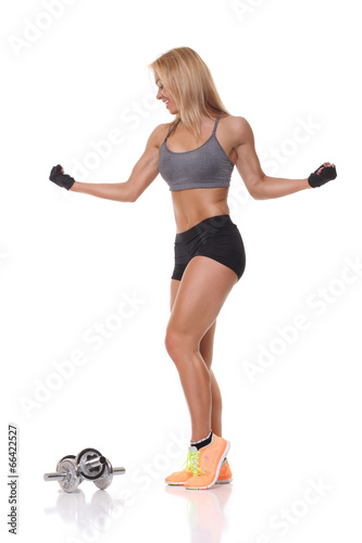 beautiful fitness female posing on studio background