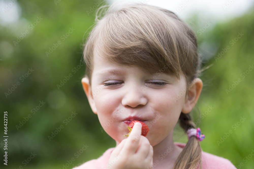Portrait of a cute little girl eating strawberries Portrait of a cute little girl eating strawberries