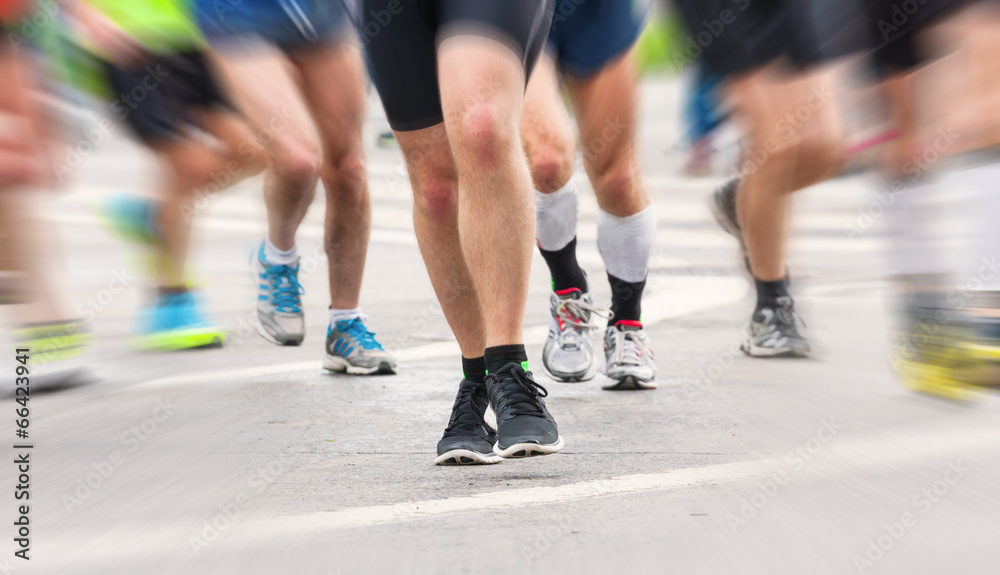 detail of the legs of runners at the start of a marathon race