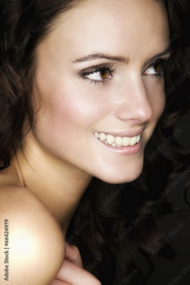 Obraz premium Beautiful young woman with long brown hair. Pretty model smiling
