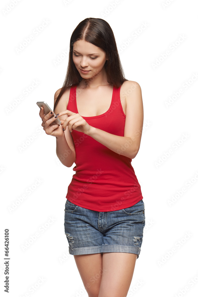 Woman sending a sms on cell phone Woman sending a sms on cell phone