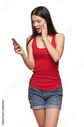 Surprised happy woman reading a sms on cell phone