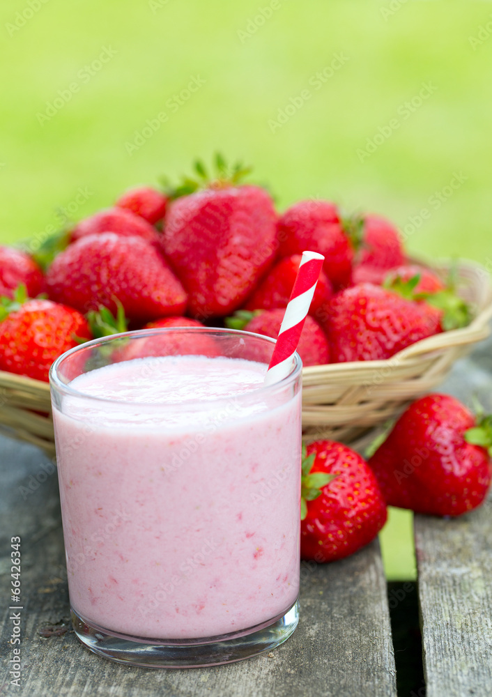 strawberry milk shake on wooden garden table strawberry milk shake on wooden garden table