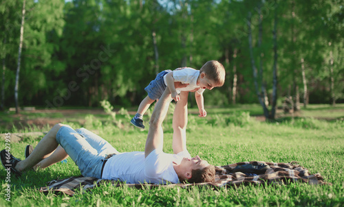 Father and son rest in the park, having fun, family, happiness