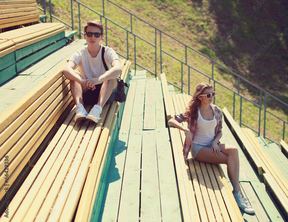 Cool hipster couple resting on the bench, youth, fashion
