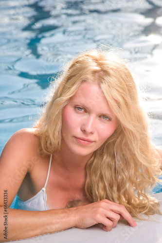 Beautiful young woman at summer swimming pool © Netfalls