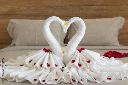 Fototapeta Naklejka Na Ścianę i Meble -  Bedroom interior design with swans from the towel decoration on