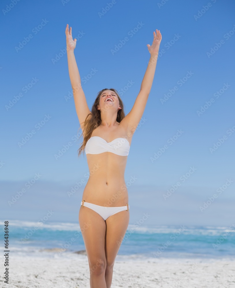 Beautiful happy blonde on the beach in white bikini Beautiful happy blonde on the beach in white bikini