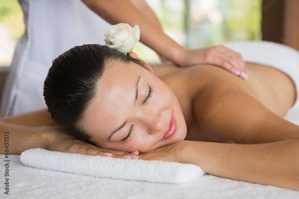 Brunette enjoying a peaceful massage with eyes closed Brunette enjoying a peaceful massage with eyes closed