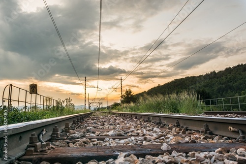 Railroad tracks running towards sunset