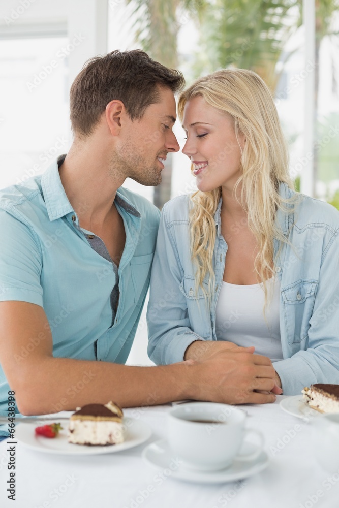 Hip young couple having desert and coffee together Hip young couple having desert and coffee together