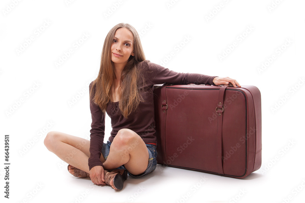 Girl sitting near a suitcase, isolated on white Girl sitting near a suitcase, isolated on white