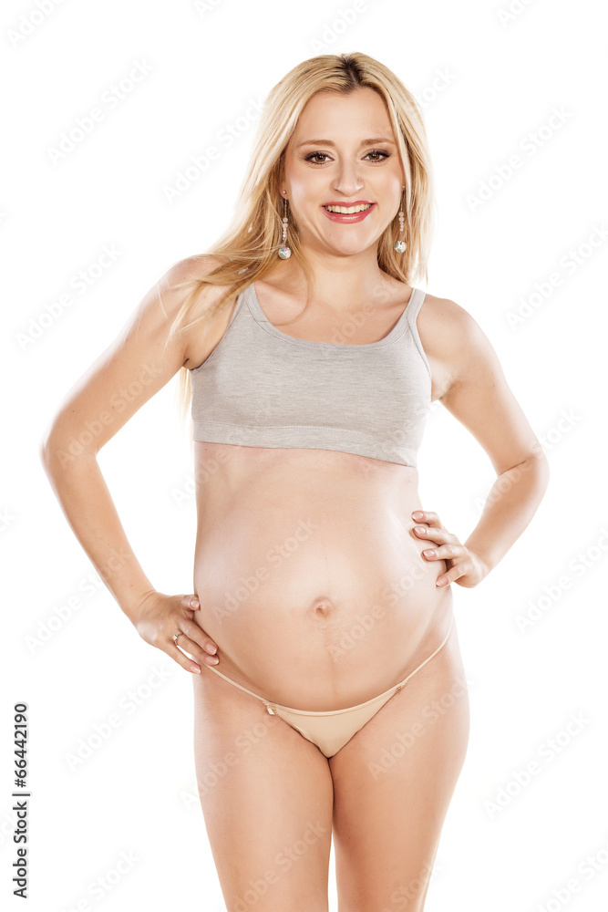Obraz premium Pregnant woman posing on a white background