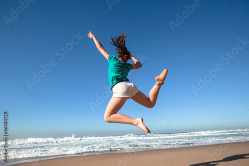 Girl Jumping Blue Beach Waves