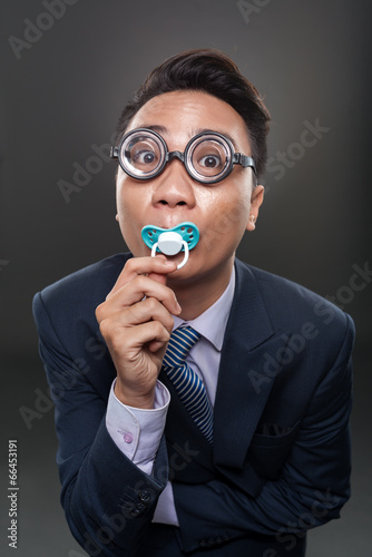 Billede på lærred Businessman with a soother