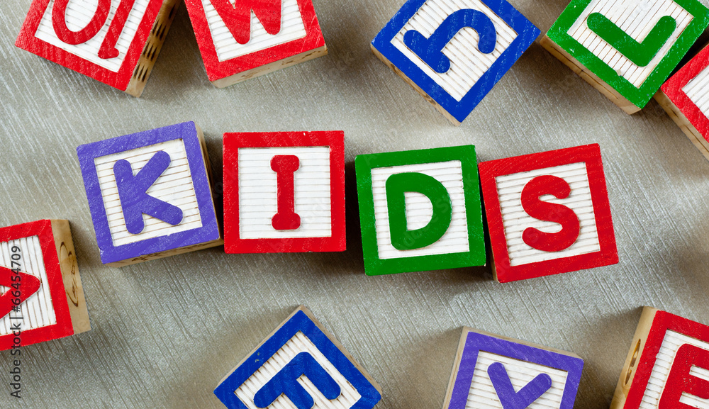 Wooden blocks forming the word KIDS in the center Wooden blocks forming the word KIDS in the center