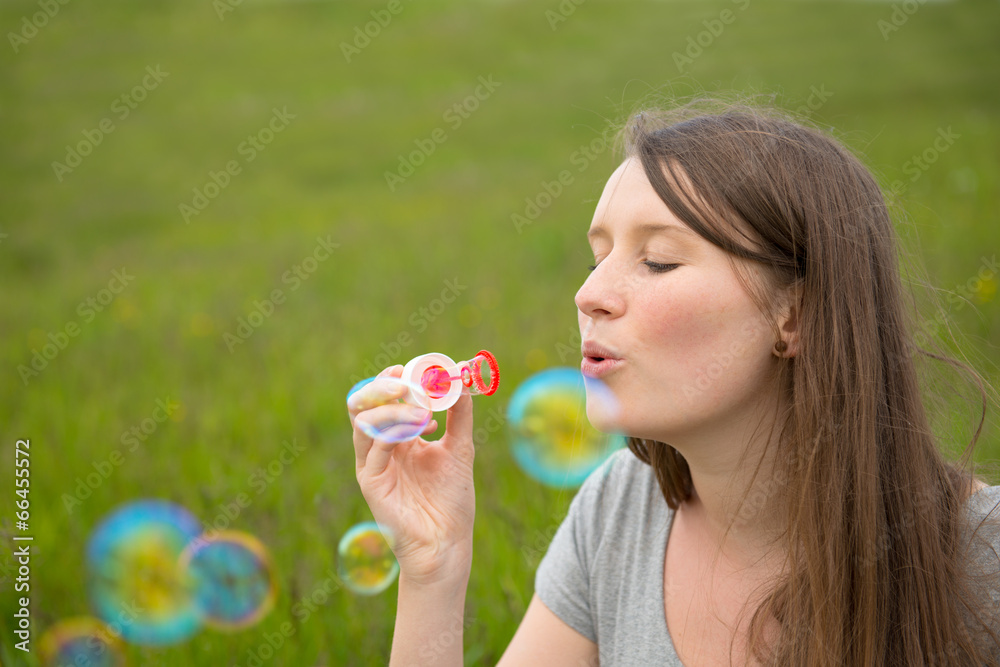 young woman blowing bubbles