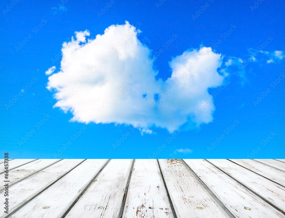 Blue sky with clouds and wooden plank