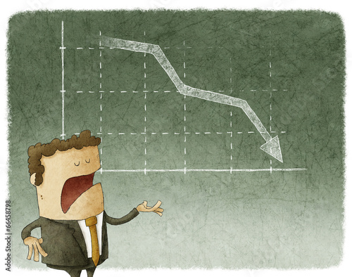 Businessman standing in front of a declining stock chart