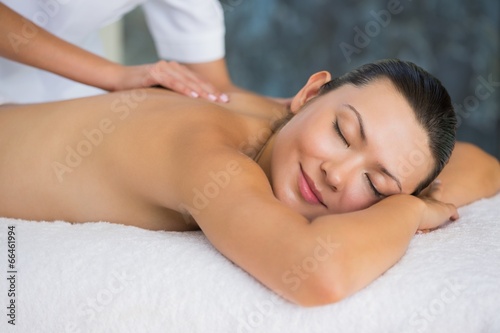 Smiling brunette enjoying a back massage