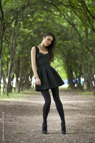 Lady in black dress in summer park