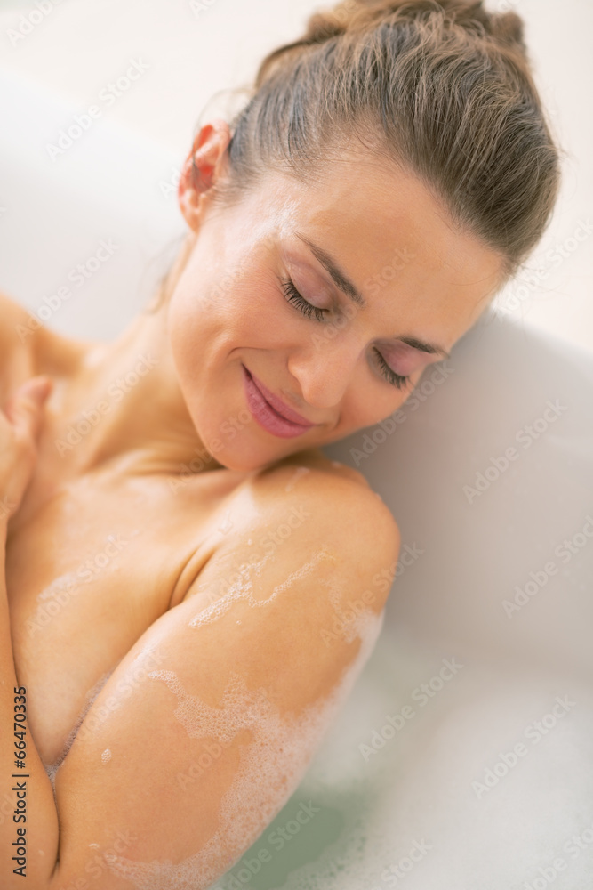 Portrait of relaxed young woman laying in bathtub Portrait of relaxed young woman laying in bathtub