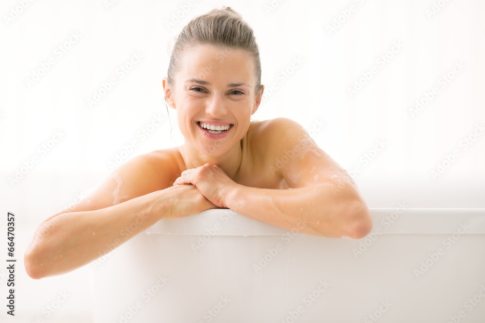 Portrait of smiling young woman in bathtub Portrait of smiling young woman in bathtub