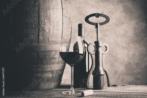 Fine wine glass bootle and barrel on wooden table Fine wine concept Wine tasting concept photo