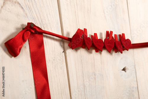 valentines day. red hearts hung on a wooden wall