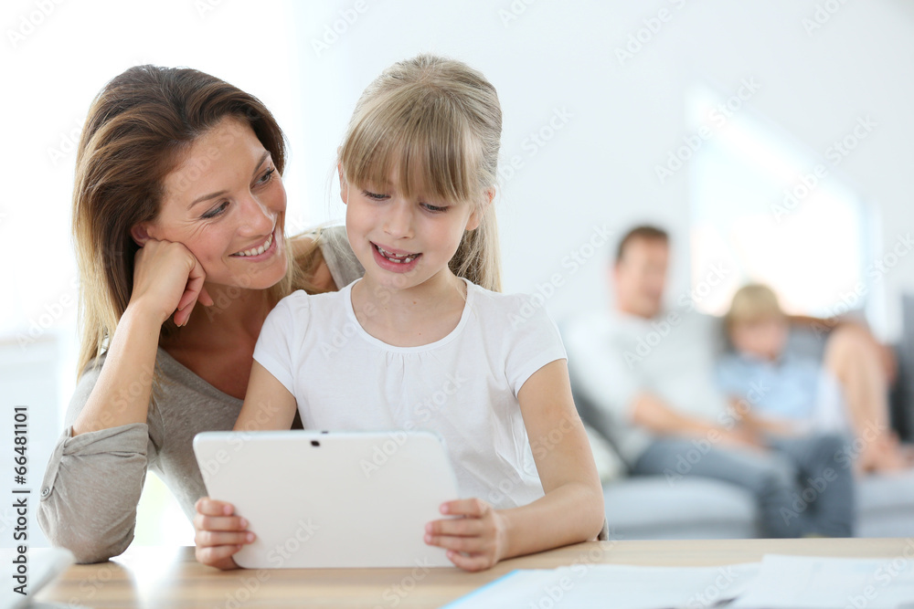 Mother and daughter using tablet at home Mother and daughter using tablet at home