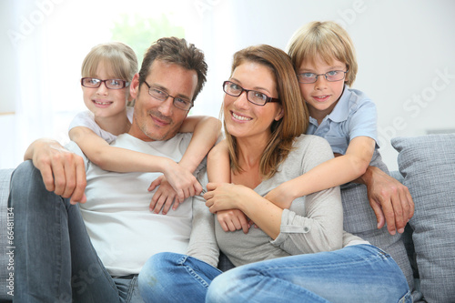 Portrait of happy family of four wearing eyeglasses