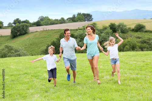 Happy family running in countryside