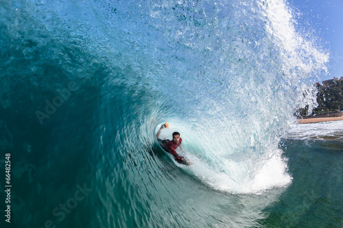 Obraz Surfing Body-Boarder Rides Inside Hollow Blue Wave