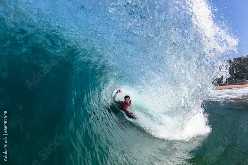 Obraz Surfing Body-Boarder Rides Inside Hollow Blue Wave